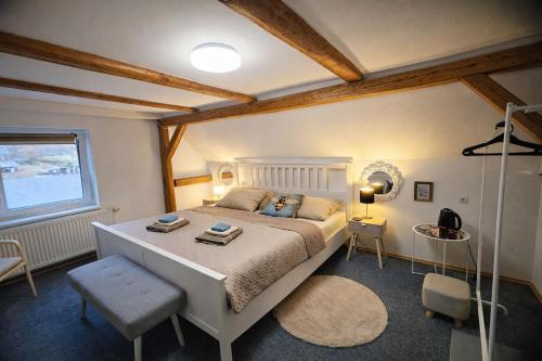 a bedroom with a large bed and a window at hostinec Thérése in Petrovice