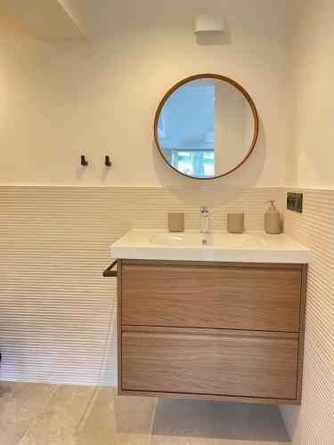 a bathroom with a sink and a mirror at Mas de Méjas Chambre d'hôtes La Pierraille in Calvignac