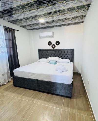 a bedroom with a large white bed in a room at Apartamentos el mochilero frente al mar piso 2 apto 3 in Cartagena de Indias
