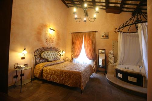 a bedroom with a bed and a tub in it at Relais Castrum Boccea in Boccea