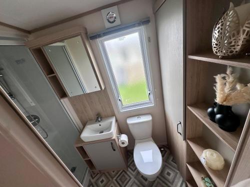 a small bathroom with a toilet and a sink at Blue dolphin static in Gristhorpe