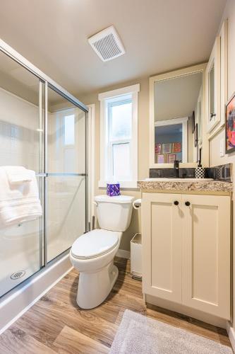 a bathroom with a toilet and a glass shower at Rainforest Tiny Home Retreat #17 Abstract Modern in Forks