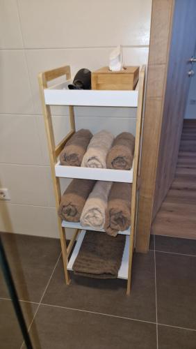 a towel rack with towels on it in a bathroom at Appartements Stadler in Breitenbrunn