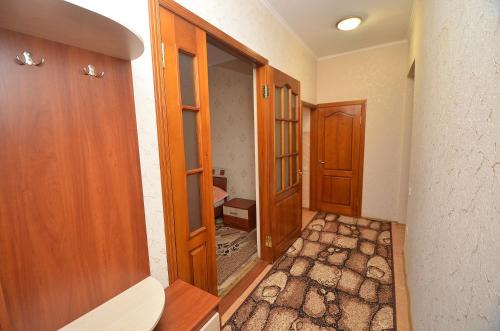 a hallway with two wooden doors and a room at Apartment in the center on Spasskaya Street in Mykolaiv