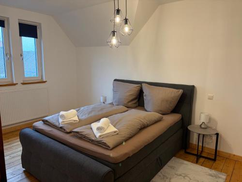 a bed in a room with two towels on it at Business Apartment in Paderborn