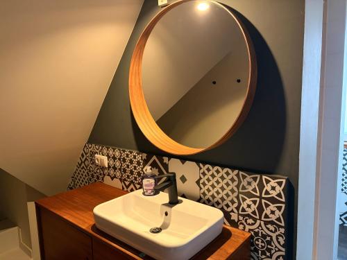 a bathroom with a sink and a large mirror at Business Apartment in Paderborn