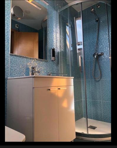 a bathroom with a shower and a sink at El Rinconcito de Foz in Foz