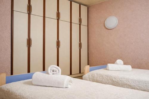 a room with two beds with towels on them at Hana's Apartment in Durrës