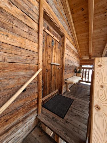 an inside view of a wooden cabin with a door at Leitingerhof in Virgen