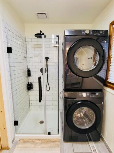 a washing machine in a bathroom with a shower at The Willowdell Nook in Mulvane