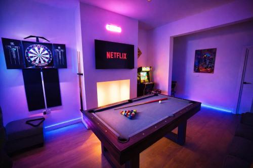 a room with a pool table and a dart board at Game Zone, Trafford Centre Nearby, Sleeps 8 in Manchester