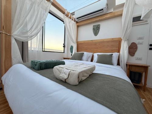 two large beds in a room with a window at Casa Luna Beach-Front Suite in Dahab