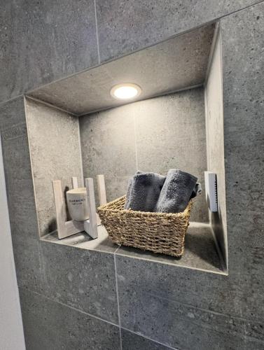 a bathroom with a basket of towels in a mirror at Holiday by Chelly in Zeitz