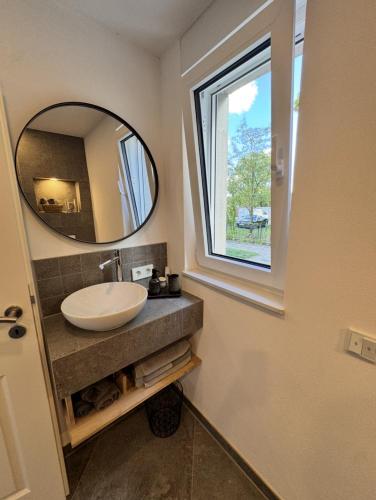 a bathroom with a sink and a mirror at Holiday by Chelly in Zeitz