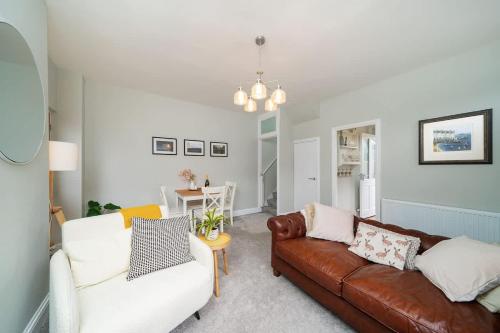 a living room with a couch and a table at Robins Nest Cottage in Blairgowrie