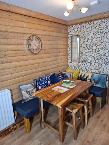 a dining room with a wooden table and chairs at The Swallow's Return LogCabin, Carlingford, A91D954 in Carlingford