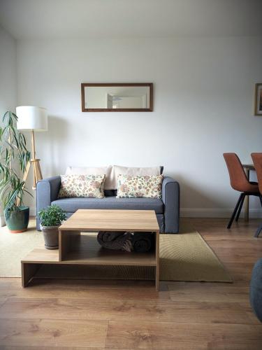 a living room with a blue couch and a coffee table at Trim private rooms in Trim