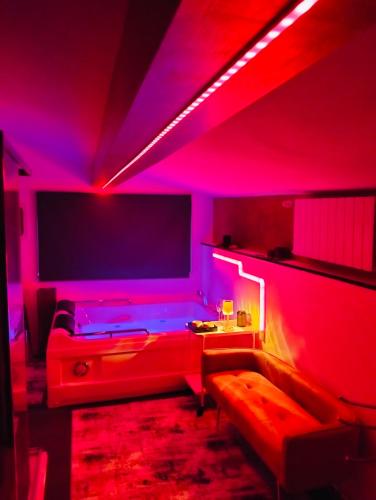 a room with a couch and a tv with red lights at Tudesia royal suite in Todi