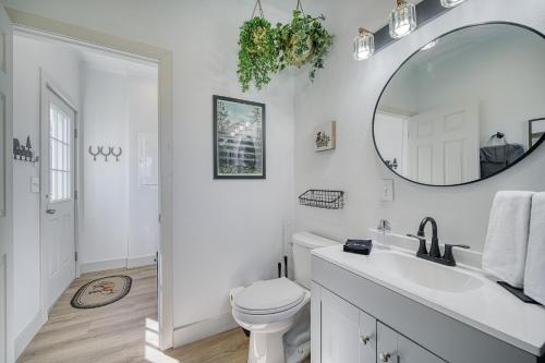 a white bathroom with a sink and a mirror at 3 King Beds Spacious 4 BR 3 BATH AC Near Jackson in Victor
