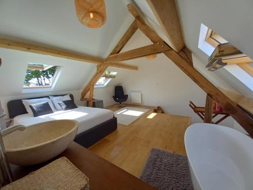 a bedroom with a bed and a bathroom with a tub at CountrySide Heaven in Neuilly-sur-Eure