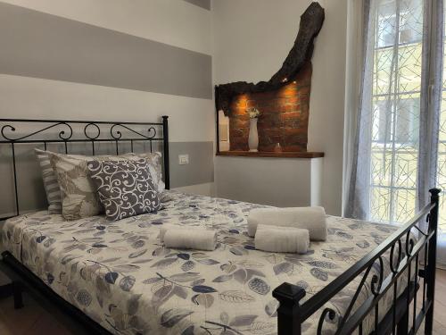 a bedroom with a large bed with pillows at L'Eden in Casarza Ligure