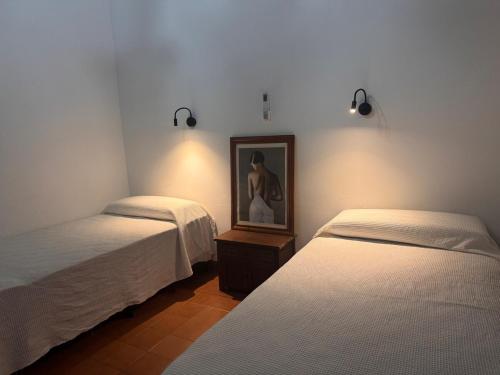 a room with two beds and a picture on the wall at Moon of Salta in Salta