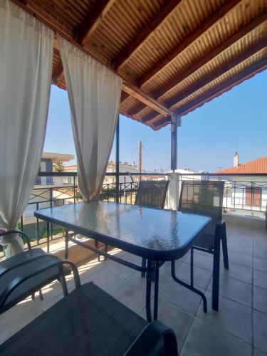 a blue table and chairs on a balcony at O&A Kallithea in Kallithea Halkidikis