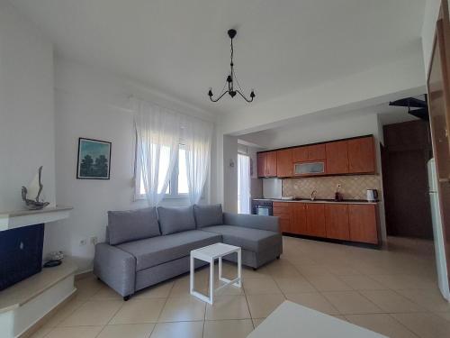 a living room with a couch and a table at O&A Kallithea in Kallithea Halkidikis