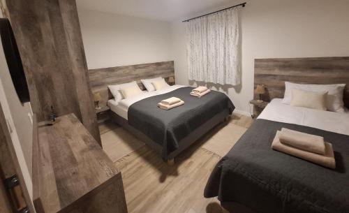 a bedroom with two beds with towels on them at apartmány TASIA in Mýto pod Ďumbierom