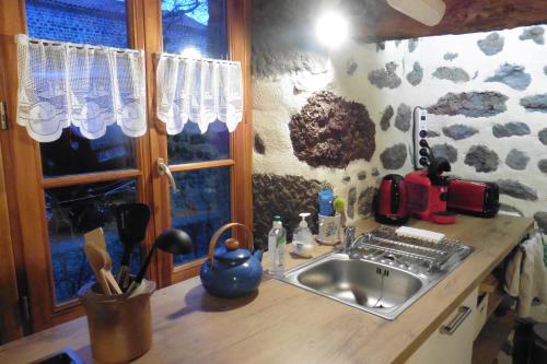 a kitchen counter with a sink and a window at la Loge à SANSSAC in Sanssac-lʼÉglise