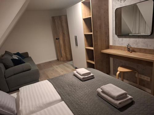 a bedroom with a bed with two towels on it at apartmány TASIA in Mýto pod Ďumbierom