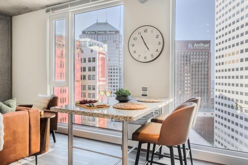 a dining room with a large window with a clock at Skyline Sanctuary in Cleveland