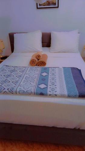 a bed with two towels on top of it at Chez Fatima et Hervé in Somone