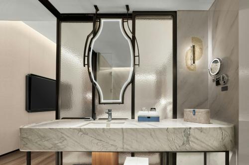 a bathroom with a sink and a mirror at Sheraton Suzhou Yangcheng Lake in Suzhou