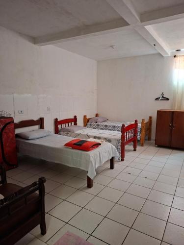 a bedroom with two beds in a room at Meu Aconchego in Embu