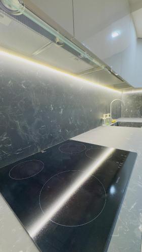 a kitchen with a black counter top with a light at Ca Rolina in Camagna Monferrato