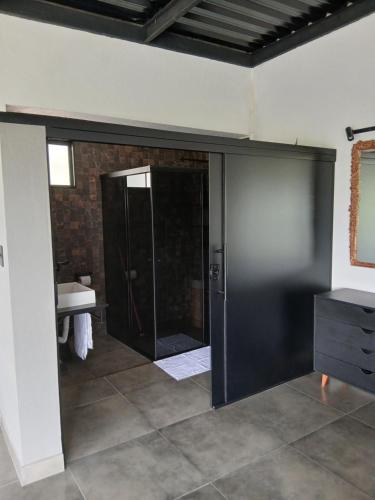 a bathroom with a shower and a glass door at Casa com piscina aquecida, estilosa e privativa in Nazaré Paulista