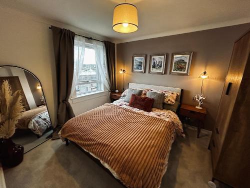 a small bedroom with a bed and a window at Newton Marina View in Stornoway