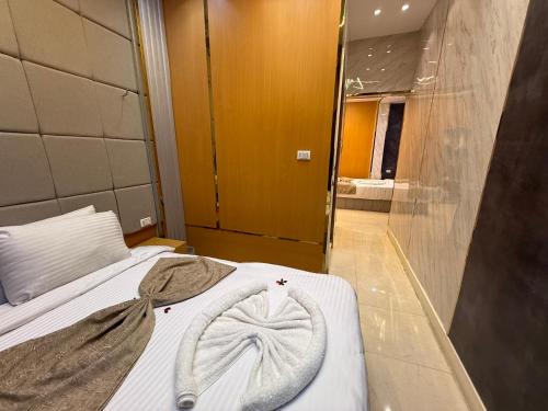 a bedroom with a bed in a room with a mirror at Glow Pyramids View Hotel in Cairo