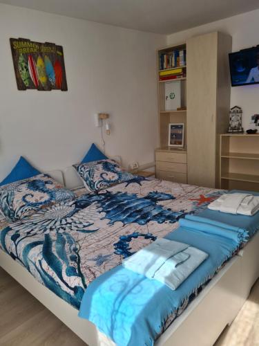 a bedroom with a bed with a blue comforter at 20 a Trieste in Trieste