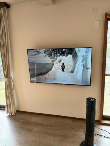 a flat screen tv hanging on a wall at Fuka in Beppu -New Open January2026 in Beppu