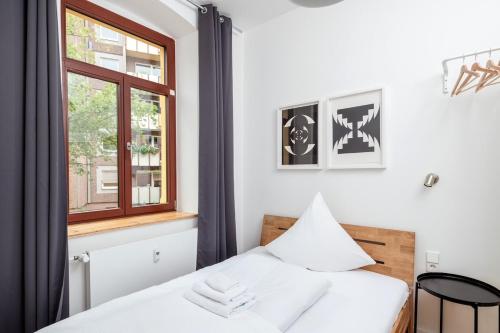 a bedroom with a white bed and a window at City apartment - small but nice in Gera