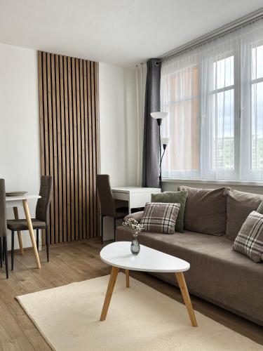 a living room with a couch and a table at Smarty Choice Living with FREE PARKING - Vondroušova in Prague