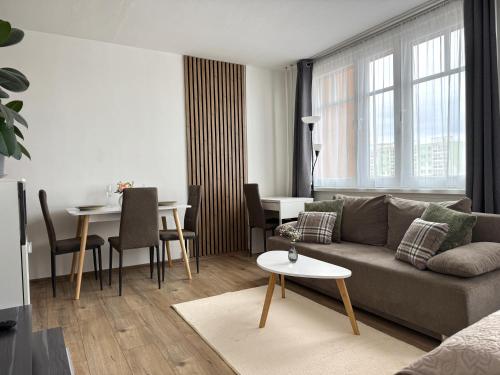 a living room with a couch and a table at Smarty Choice Living with FREE PARKING - Vondroušova in Prague