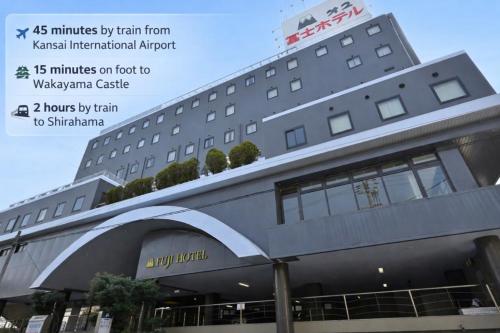 a building with a sign on the front of it at Wakayama Daini Fuji Hotel in Wakayama