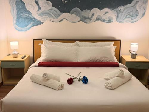 a bed with two pairs of scissors and towels on it at Victoria guesthouse in Rome