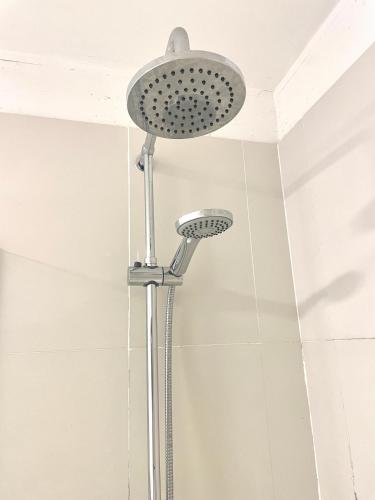 a shower with a shower head in a bathroom at Apartamentos Libertador, Martinez in Martínez