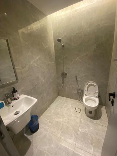 a bathroom with a toilet and a sink at Condo in Alramal near to the airport in Riyadh