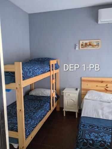 a bedroom with two bunk beds in a room at Alquituc Escobar in Belén de Escobar