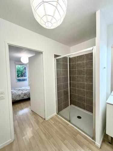 a bathroom with a glass shower in a room at Villeneuve, in Villeneuve d'Ascq